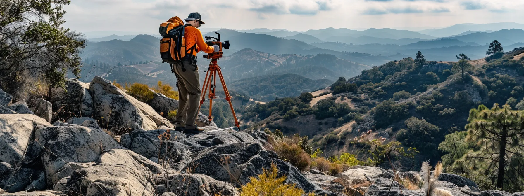 a surveyor adjusting a total station on a rocky california hillside, ensuring precise measurements in diverse terrains.